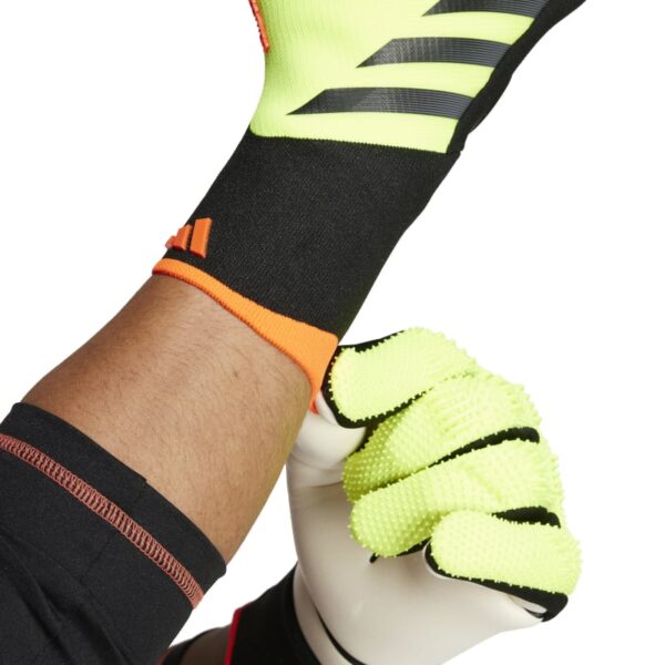 כפפות שוער Adidas Predator Pro Yellow על ידיים של שוער מושך ביד שמאל את הכפפה ביד ימין לעבר המרפק רואים רק את הידיים עם כפפות
